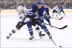  ?? CP PHOTO NATHAN DENETTE ?? Toronto Maple Leafs centre Auston Matthews and San Jose Sharks right wing Kevin Labanc battle Wednesday during second period NHL hockey action in Toronto.