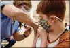  ?? BILL LACKEY/STAFF ?? Piper Atkinson, 16, gets her first COVID vaccine injection Tuesday at the Clark County vaccine distributi­on center at the Upper Vally Mall.