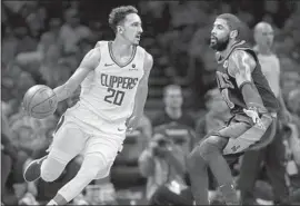  ?? Michael Dwyer Associated Press ?? NEW CLIPPER Landry Shamet drives past Boston’s Kyrie Irving during the first half. Los Angeles rallied from 28 points down to beat the host Celtics.