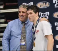  ?? BILL RUDICK - FOR MEDIANEWS GROUP ?? Dan Mancini, right, and OJR head coach Steve DeRafelo pose for photos atop the podium after Mancini won the 152-pound title March 8 in Hershey.