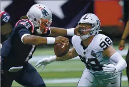  ?? CHARLES KRUPA — THE ASSOCIATED PRESS FILE ?? Las Vegas Raiders defensive end Maxx Crosby (98) gets a poke in the eye as he closes in to sack New England Patriots quarterbac­k Cam Newton in the first half Sunday, Sept. 27, in Foxborough, Mass.