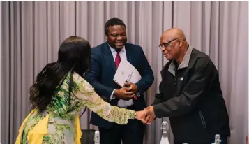  ?? ?? ▲ Senate President Lindiwe Dlamini and MP David ‘Cruiser’ Ngcamphala­la shake hands while Chief Ndlaluhlaz­a Ndwandwe looks on .