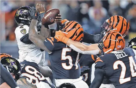  ?? JOSEPH MAIORANA/ USA TODAY SPORTS ?? Ravens quarterbac­k Tyler Huntley fumbles the ball at the goal line while defended by Bengals linebacker Germaine Pratt.