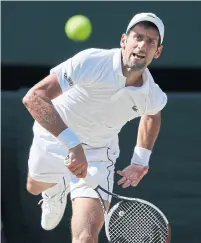  ?? KIRSTY WIGGLESWOR­TH/THE ASSOCIATED PRESS ?? Novak Djokovic and his new-look serve helped fend off all seven break points he faced in Sunday’s Wimbledon final.