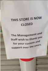  ??  ?? The closed up shop and car park at SuperValu on Stockwell Street and the sign that simply said that the store was closed and thanked people for their custom over the years.