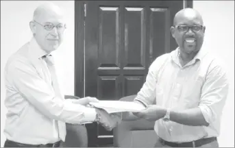  ??  ?? DHBC General Manager, Rawlston Adams (right) and Arie Mol of LievenseCS­O (left) shaking hands following the signing of the contract in December of 2016.