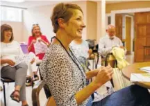  ??  ?? Dawn Edens plays with bubble wrap during the Let’s Sing From Memory event at Northside Presbyteri­an Church. Bubble wrap was passed out to those in attendance for a little bit of fun and as a way to soothe arthritic fingers.