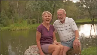  ?? Tina Larkin/File photo ?? Edy and Dr. Charlie Anderson sit near a pond on their Taos property in 2013, the year she was named an Unsung Hero.