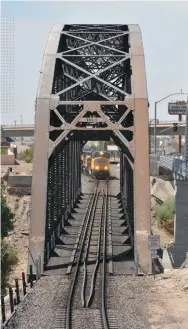  ??  ?? A westbound Union Pacific Railroad train
leaves the Yuma Yard,
headed to California via the railroad bridge over the Colorado River, built in
1923.