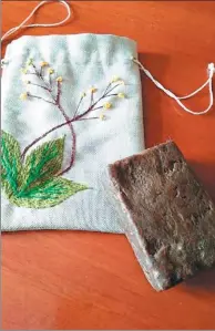  ?? PHOTOS PROVIDED TO CHINA DAILY ?? A piece of black soap and its packing bag made by Kazakh women in a soap-making workshop in Qinghe county, in the Xinjiang Uygur autonomous region.