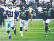  ?? AP/RON JENKINS ?? Dallas Cowboys running back Ezekiel Elliott (left) runs against the Seattle Seahawks on Saturday in Arlington, Texas.