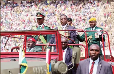  ??  ?? Commander-in-chief of the Zimbabwe Defence Forces President Mnangagwa and Zimbabwe Defence Forces Commander General Phillip Valerio Sibanda inspect a Guard of Honour during Defence Forces Day celebratio­ns at the National Sports Stadium in Harare yesterday