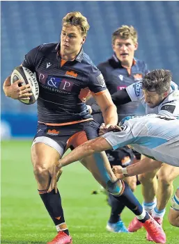  ?? Picture: PA. ?? Edinburgh’s Duhan van der Merwe is tackled by Glasgow Warriors’ Scott Cummings at Murrayfiel­d.