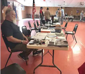  ?? Staff Photo ?? Vietnam Veterans of America Chapter #278 President Greg Beck waits to distribute Veterans Administra­tion informatio­n to local veterans as they stopped by the Veterans of Foreign Wars Post #4562 during a four-hour Veterans Benefit Fair, held at the post Saturday. Two more fairs could be scheduled before the end of this year.