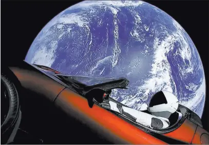  ??  ?? The Associated Press This image from video provided by Spacex shows the company’s spacesuit in Elon Musk’s red Tesla sports car, which was launched into space during the first test flight of the Falcon Heavy rocket Tuesday.