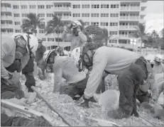  ??  ?? MIAMI
Rescue workers dig through the rubble at the site of the collapse in Surfside, Fla.
-REUTERS