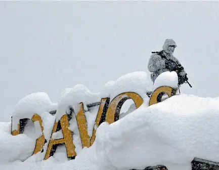  ?? PHOTO: AP ?? An armed Swiss police officer stands guard on the roof of a hotel near where the annual meeting of the World Economic Forum is taking place in Davos.