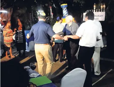  ?? PHOTOS BY PAUL H. WILLIAMS ?? People dancing to Jewish music during the 2018 celebratio­ns of Chanukah on the grounds of Terra Nova All-Suites Hotel.
