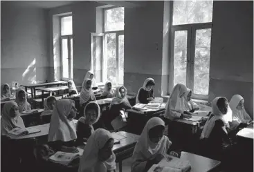  ?? FELIPE DANA/AP ?? Girls prepare for class Sunday at a school in Kabul, Afghanista­n.