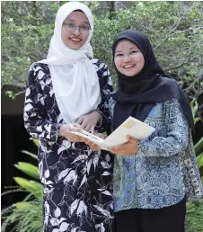  ?? ?? Former street kids Puteri Nur Arissa (right) and Puteri Umira are now pursuing degrees at UKM.