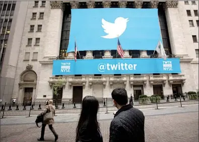  ?? Bloomberg News/SCOTT EELLS ?? The Twitter logo is displayed on a banner outside the New York Stock Exchange on Thursday. Shares of the Internet social network company surged 70 percent Thursday in their first day of trading.