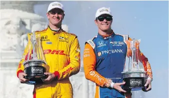  ??  ?? Ryan Hunter-Reay, left, and Scott Dixon pose with their first place trophies after the second race of the IndyCar Detroit Grand Prix auto racing doublehead­er on Sunday.