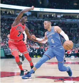  ?? — USA Today Sports ?? Oklahoma City Thunder’s Russell Westbrook (0) dribbles the ball against Chicago Bulls’ Justin Holiday during the first half at the United Center.