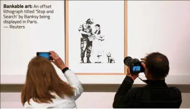  ?? — Reuters ?? Bankable art: An offset lithograph titled ‘ Stop and Search’ by Banksy being displayed in Paris.