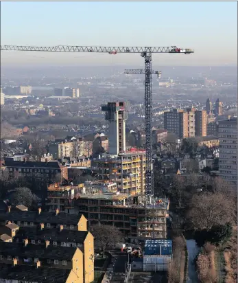  ?? PHOTO: BLOOMBERG ?? A crane stands above a block of residentia­l apartments under constructi­on at the Berkeley Group Holdings Plc Woodberry Down developmen­t in London. The UK is looking to build 1 million homes by 2020.