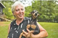  ?? KEITH MCCOY/BOONE NEWSPAPERS VIA AP ?? 2nd Chance Animal Sanctuary owner Sandra Shaffer holds Jada, a black and brown miniature pinscher that is one of more than 40 dogs currently living at the sanctuary, in Hayden, Ala.