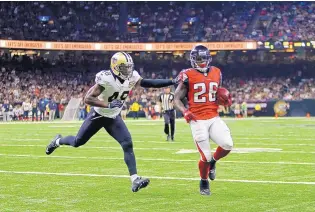  ?? BUTCH DILL/ASSOCIATED PRESS ?? Atlanta running back Tevin Coleman (26) crosses into the end zone for one of his three touchdowns during the Falcons’ win over the New Orleans Saints Monday.