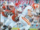  ?? Karl B Deblaker The Associated Press ?? N.C. State’s Jaylon Scott (2) tackles Clemson’s Will Shipley in the Wolfpack’s upset win.