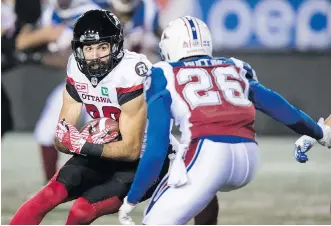  ?? PAUL CHIASSON/THE CANADIAN PRESS ?? Ottawa Redblacks wide receiver Brad Sinopoli braces for impact as he’s tracked down by Montreal Alouettes defensive back Tyree Hollins Thursday during the Redblacks’ 32-4 win.