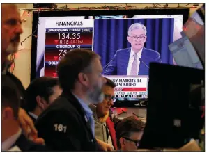  ?? (AP/Richard Drew) ?? A television screen on the floor of the New York Stock Exchange shows Federal Reserve Board Chairman Jerome Powell speaking last month. The Fed Board on Thursday approved a proposal to ease restrictio­ns on Wall Street banks’ investing in venture capital funds.