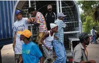  ?? ?? Haitian migrants, detained by immigratio­n officials in Dajabon, Dominican Republic, step out of a bus to be deported.