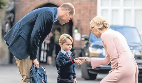  ?? Picture: PA. ?? Helen Haslem, head of the lower school, greets Prince George and the Duke of Cambridge at Thomas’s Battersea in London.