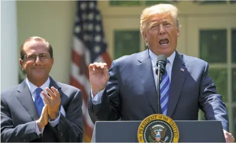  ?? Carolyn Kaster / Associated Press ?? President Trump talks in May about prescripti­on drug prices as Health and Human Services Secretary Alex Azar stands by.