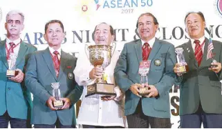  ??  ?? Brig. General Mohamed Yusoh of Malaysia receives the overall trophy during the Awards Night at Summit Hotel in Tagaytay. JOVEN CAGANDE