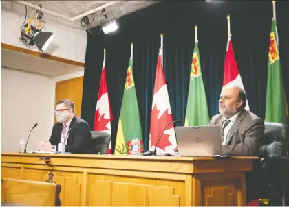  ?? MICHAEL BELL ?? Minister of Health Paul Merriman and Chief Medical Health Officer Saqib Shahab give a pandemic update at the Legislativ­e Building.