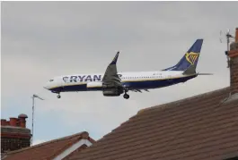  ?? (Phil Noble/Reuters) ?? A RYANAIR PLANE prepares to land at Manchester Airport in northern England last year