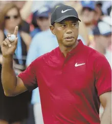  ?? AP PHOTO ?? SO CLOSE: Tiger Woods, who shot 64 and finished second, waves to the crowd after making a par putt during yesterday’s final round of the PGA Championsh­ip.