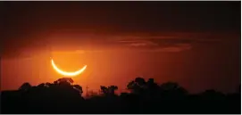  ?? MARCOS BRINDICCI – THE ASSOCIATED PRESS ?? The moon passes in front of the setting sun during a total solar eclipse in Buenos Aires, Argentina, on July 2, 2019.