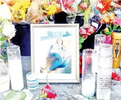  ??  ?? Flowers and a photograph are seen at a memorial for Corado was killed in shootout between police and a gunman in Los Angeles, California. — AFP photo