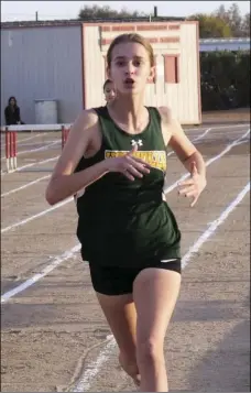  ??  ?? Holtville High’s Amanda Strahm leads in the girls’ 800-meter event during an Imperial Valley League track meet at Imperial High on Thursday.