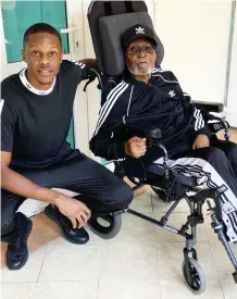  ??  ?? Robert Jr with his wheelchair-bound ailing father in June