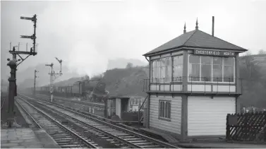  ?? James Harrold/Transport Treasury ?? Viewed from the down through platform on 17 December 1960, Hasland-allocated Stanier ‘8F’ class 2-8-0 No 48065 passes behind the Midland Railway built Chesterfie­ld North signal box as it plods by on the up goods line from Tapton Junction with a rake of mineral wagons. It will soon cross the River Rother, which flows east to west under a pair of bridges, one for the goods lines and the other for the passenger station. The main passenger facilities are south of the river crossing, which restricted the layout of the site. However, immediatel­y north of the river there was an north-facing down bay and adjacent siding, and south of the river there were similar up facilities, while up and down through roads and yards either side of the four-track created a section where 14 lines were side-by-side near the goods shed.