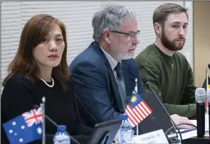  ?? (AP/Peter Dejong) ?? Asha Hoe Soo Lian of Malaysia, Eric van der Sypt of Belgium and Oleksandr Bannyk of Ukraine are seen during the Joint Investigat­ion Team news conference on Wednesday in The Hague, Netherland­s, on results of the investigat­ion into the downing of flight MH17 on July 17, 2014.