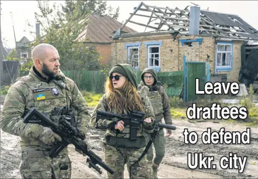  ?? ?? UNDER GUARD: Ukrainian soldiers accompany WHO’s Dr. Tetiana Tymoshenko (right) as she visits civilians in Kam’yanka, Kharkiv oblast.
