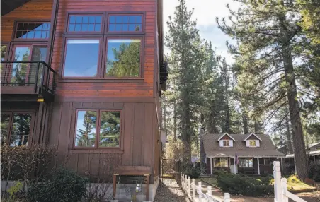  ?? Photos by Jessica Christian / The Chronicle ?? A large rental property on Lakeside Avenue towers over a small private home in South Lake Tahoe where Measure T was ahead.