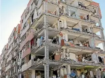  ??  ?? Apartments in an earthquake-damaged building in Sarpol-e Zahab are left open to the elements.